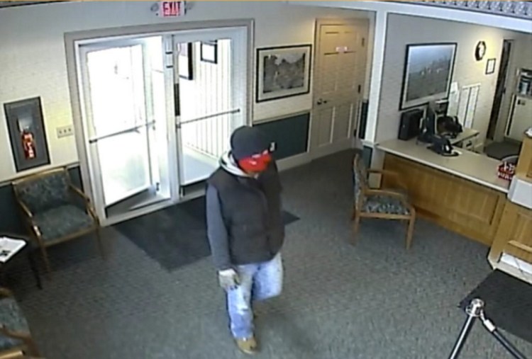 A robber enters the Skowhegan Savings Bank branch in Norridgewock in January.