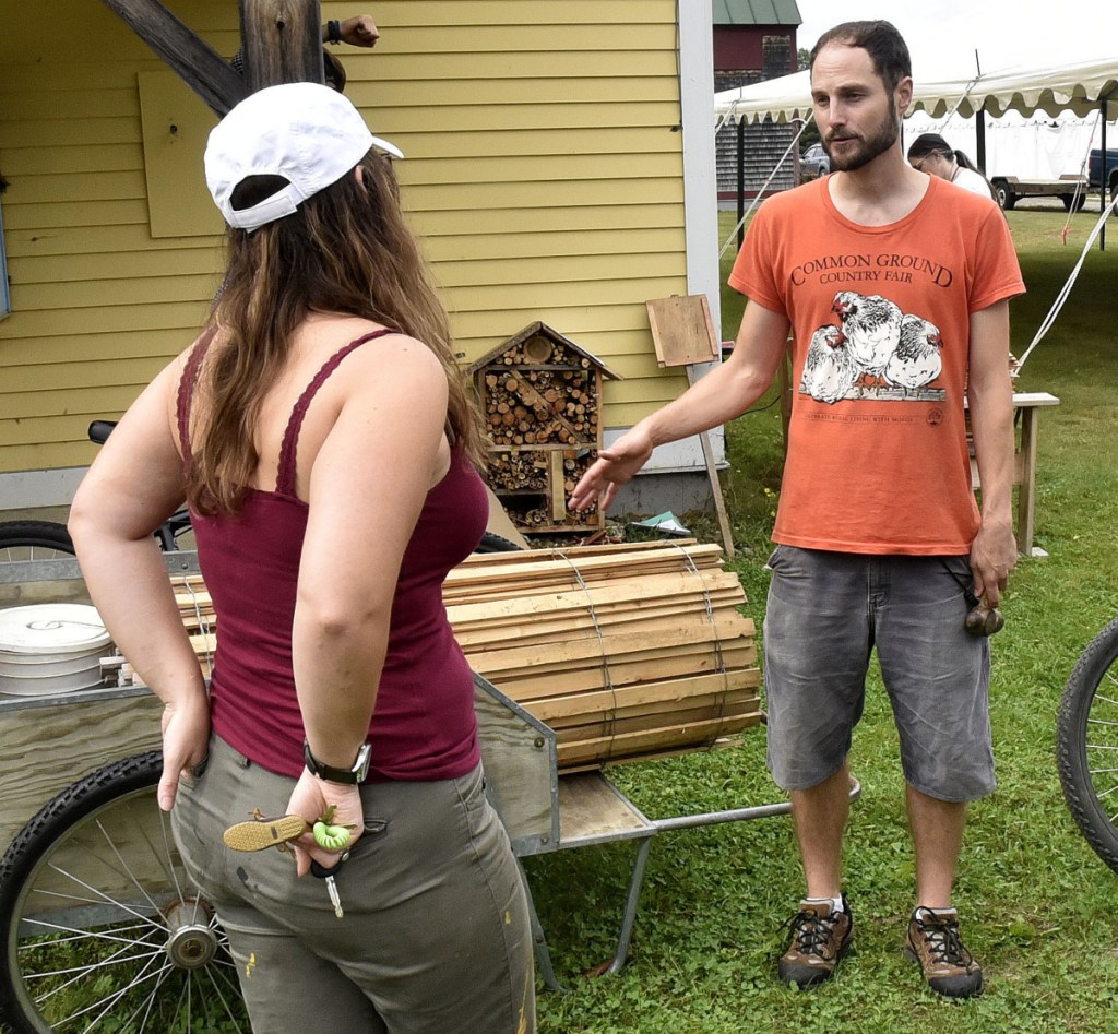 Volunteer coordinator Andrew Graham assists volunteer Edyche Morin with project ideas in preparation for the Maine Organic Farmers and Gardeners Association annual Common Ground Country Fair in Unity on Tuesday. The three-day fair starts this Friday.