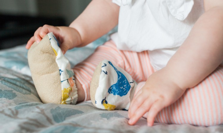 The booties have elastic around the ankle that makes them easy to get on a wiggly baby.