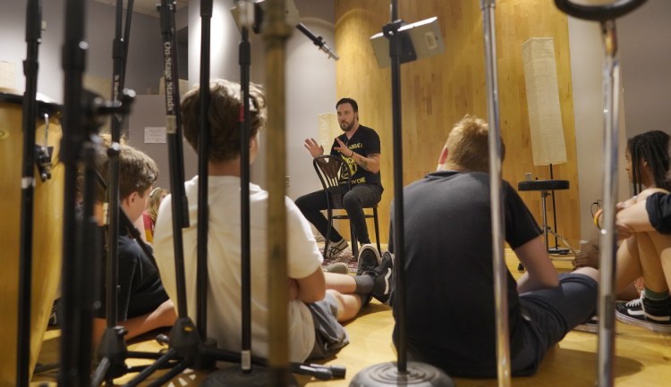 Dave Gutter, a founding member of Rustic Overtones and currently performing with the Portland band Armies,  talks with students in a songwriting camp.