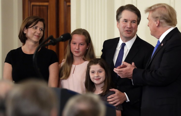 President Trump greets Judge Brett Kavanaugh and his family – from left, wife Ashley and daughters Margaret and Eliza – on July 9 in the East Room of the White House in Washington.