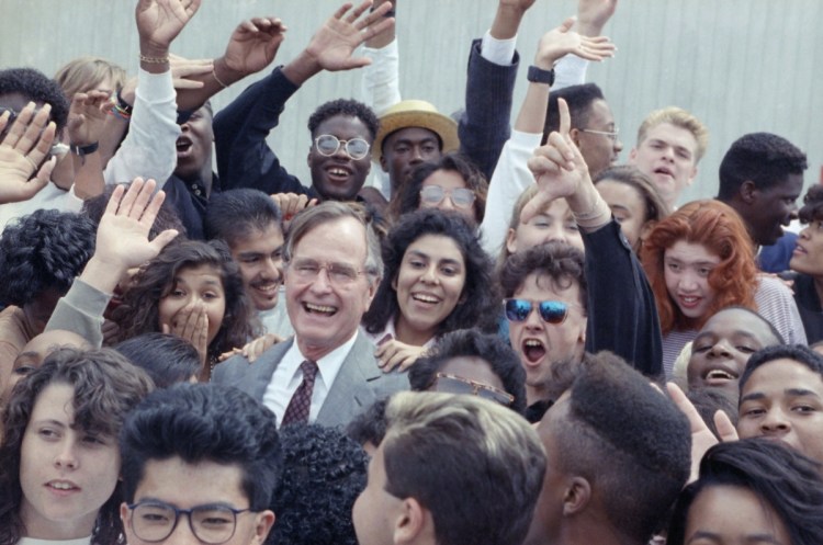 In 1990, President George H.W. Bush joins students from a Los Angeles program that assists youths who have been in foster care or on probation.