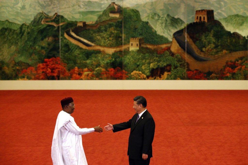 Niger President Mahamadou Issoufou, left, shakes hands with Chinese President Xi Jinping during the Forum on China-Africa Cooperation held at the Great Hall of the People in Beijing, Monday, Sept. 3, 2018. (AP Photo/Andy Wong, Pool)