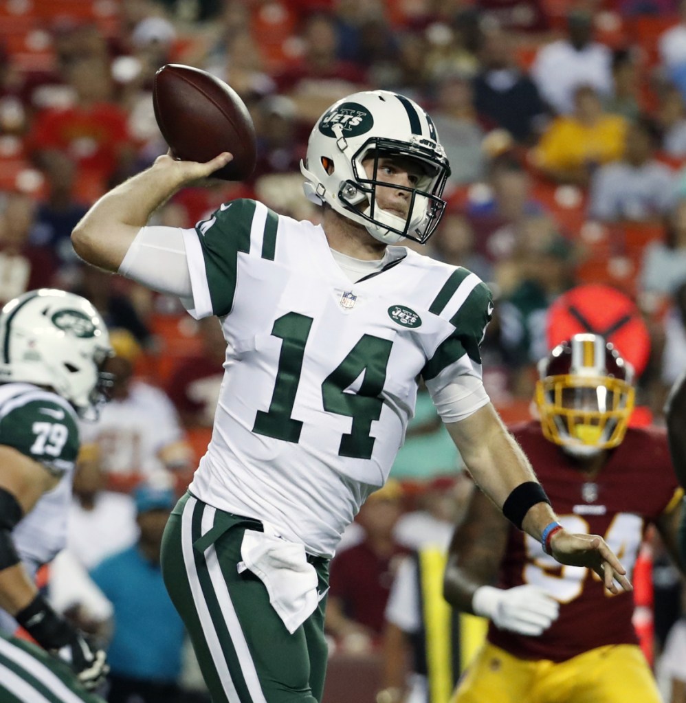 FILE - In this Aug. 16, 2018, file photo, New York Jets quarterback Sam Darnold (14) throws against the Washington Redskins during the first half of a preseason NFL football game, in Landover, Md. The Jets traded up three spots to get to No. 3 in the draft, hoping to get a potential franchise quarterback. After Cleveland took Baker Mayfield and the Giants went with running back Saquon Barkley, Sam Darnold fell right into New York's lap _ getting the guy it wanted all along. (AP Photo/Alex Brandon, File)