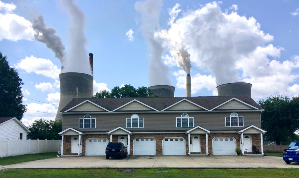 An apartment building stands in the shadow of American Electric Power's coal-fired plant in Winfield, W.Va. An EPA analysis says the health of West Virginia residents will be hit hard if Obama-era pollution controls are rolled back.