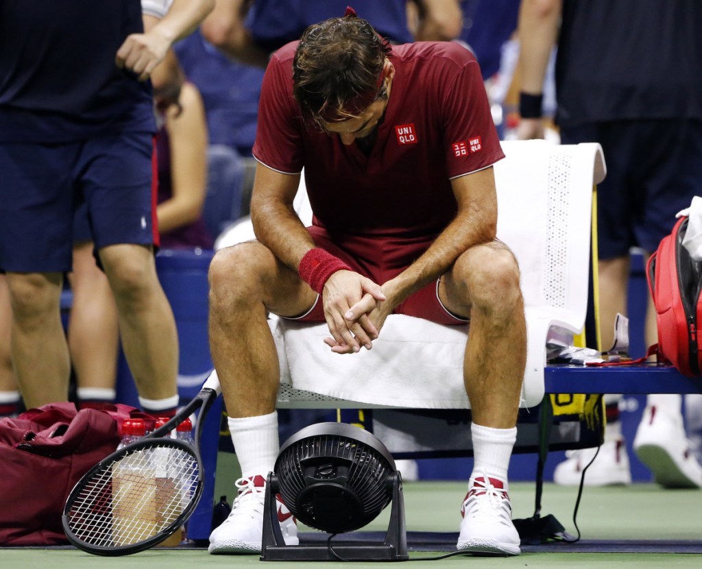 Roger Federer, of Switzerland, sits in front of a fan during a changeover in his match against John Millman, of Australia, during the fourth round of the U.S. Open tennis tournament early Tuesday, Sept. 4, 2018, in New York. (AP Photo/Jason DeCrow)
Roger Federer sits in front of a fan during a changeover in his match against John Millman at the U.S. Open early Tuesday. (AP Photo/Jason DeCrow)