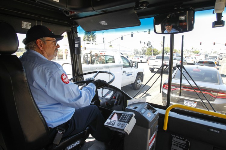 After Tom Middleton lost his job as a software engineer, he had difficulty finding a tech job despite his advanced degree. He's now employed as a bus driver for less than half the pay.