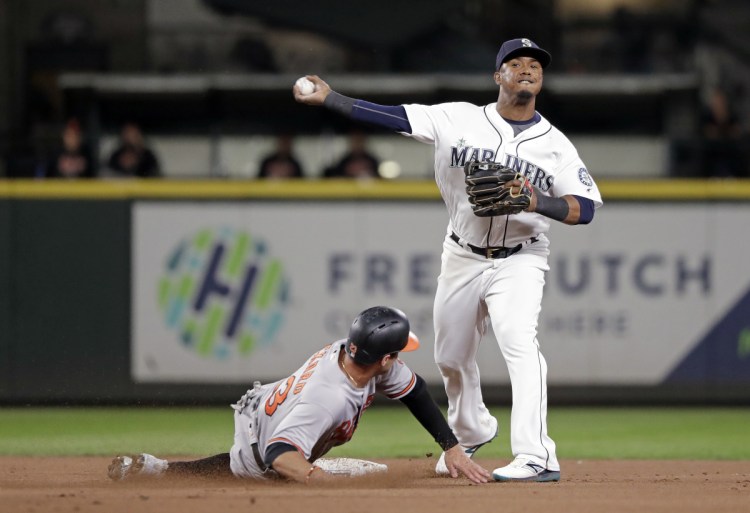 Associated Press/Elaine Thompson
Seattle Mariners shortstop Jean Segura, right, was reportedly one of the players involved in a brawl in the Mariners' lockerroom before their game Tuesday against the Baltimore Orioles.