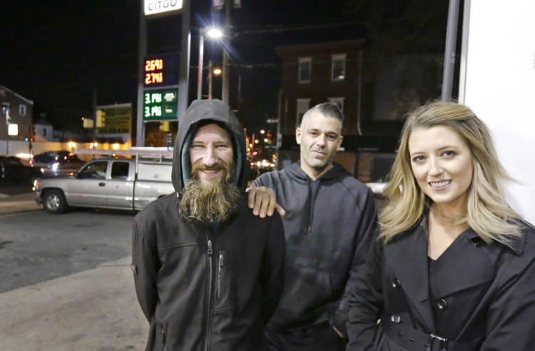 Johnny Bobbitt Jr., left, Kate McClure and McClure's boyfriend, Mark D'Amico, in 2017.  McClure and D'Amico raised more than $400,000 for Bobbitt, a homeless man, after he used his last $20 to fill her gas tank when she was stranded with no money.