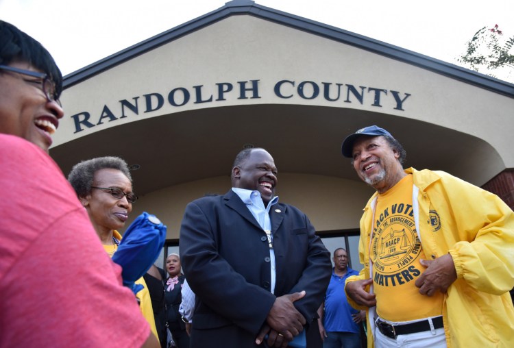 Edward DuBose of the NAACP, center, and others at Randolph County Government Center rejoice after a panel defeated an effort to close rural voting sites in Cuthbert, Ga. Municipalities across the U.S. have closed more than 800 polling places since 2013.