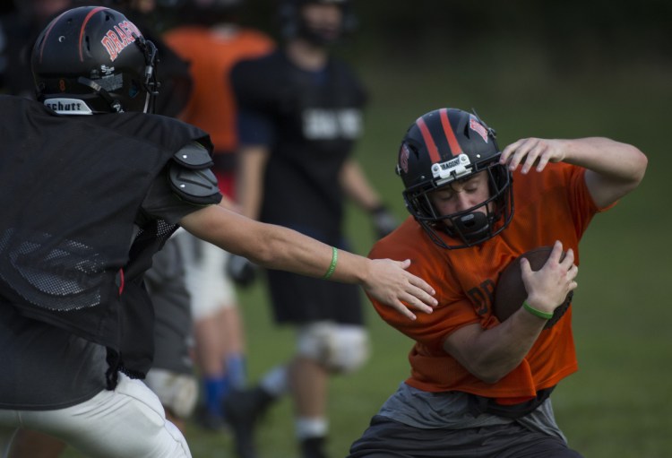Brunswick junior running back Owen Richardson, shown eluding a tackle at a preseason practice, broke his collarbone in the season opener against Falmouth and will miss six-to-eight weeks. (Staff photo by Brianna Soukup/Staff Photographer)