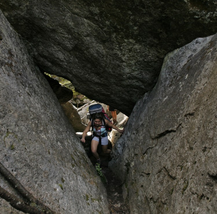 A hiker makes her way through Mahoosuc Notch in August 2006. A column reminds a reader of his own Mahoosuc Notch adventures.