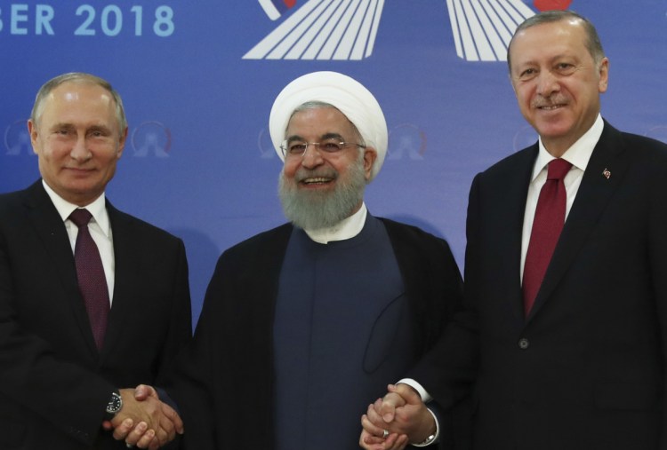 Iran's President Hassan Rouhani, center, flanked by Russia's President Vladimir Putin, left, and Turkey's President Recep Tayyip Erdogan, meet in Tehran ahead of their summit on Syria.