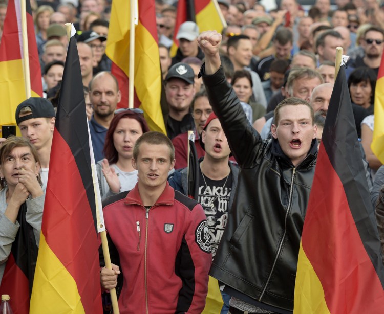 Far-right Germans march in Chemnitz on Friday. The far right is causing headaches for Chancellor Angela Merkel, who has welcomed immigrants. 