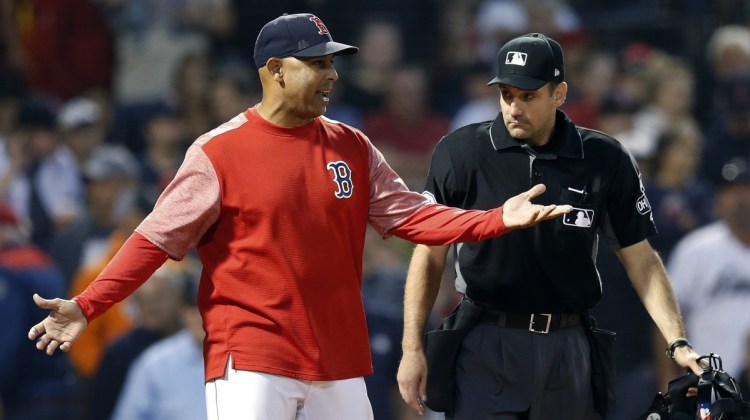 Boston Red Sox Manager Alex Cora, left, talks with plate umpire David Rackley after Ian Kinsler was called out on strikes Saturday in the eighth inning of the 5-3 loss to the Houston Astros at Fenway Park.