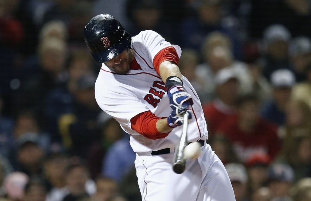 J.D. Martinez connects for a three-run homer in the fifth inning Sunday night during Boston's 6-5 win over the Astros. (Associated Press/Michael Dwyer)