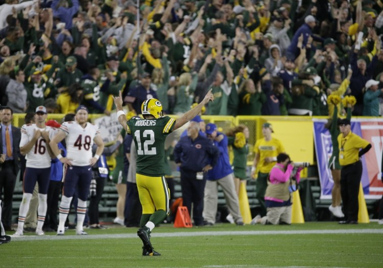 Green Bay quarterback Aaron Rodgers reacts after throwing a 75-yard touchdown pass to Randall Cobb during the second half against the Chicago Bears on Sunday night in Green Bay, Wis.