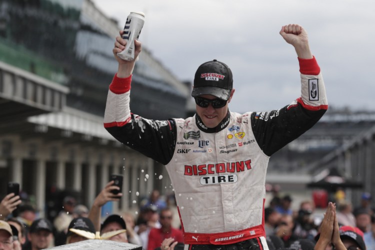 Brad Keselowski celebrates after capturing the Brickyard 400 on Monday, giving team owner Roger Penske a single-season sweep at Indianapolis Motor Speedway. Will Power won the Indy 500 for Penske in May.