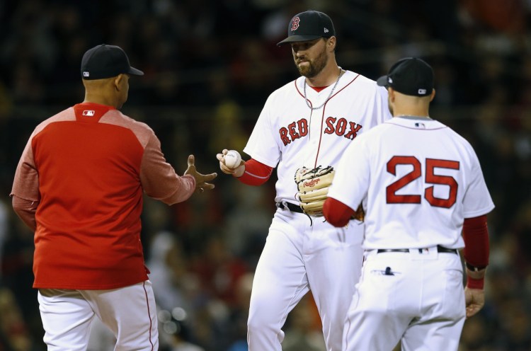 Boston Red Sox Manager Alex Cora, left, taking out Heath Hembree on Sunday night, has intriguing options for the bullpen in the playoffs. Like, say, Eduardo Rodriguez. Or Nathan Eovaldi. Or maybe an inning or two of the baffling Steven Wright.