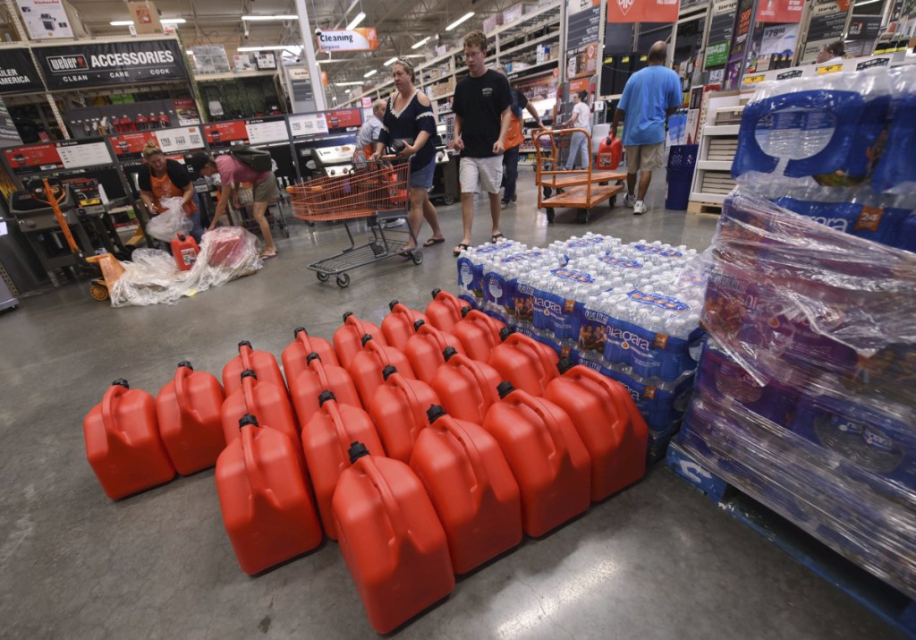 People buy supplies at The Home Depot on Monday, Sept. 10, 2018, in Wilmington, N.C. Florence rapidly strengthened into a potentially catastrophic hurricane on Monday as it closed in on North and South Carolina, carrying winds and water that could wreak havoc over a wide stretch of the eastern United States later this week. (Ken Blevins/The Star-News via AP)