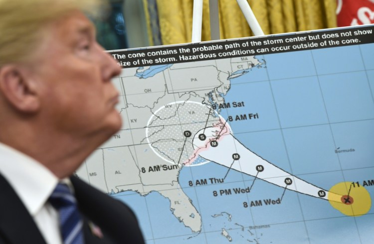 President Trump listens Tuesday during a briefing in the Oval Office on Hurricane Florence. He said, "We are absolutely, totally prepared" for the storm.