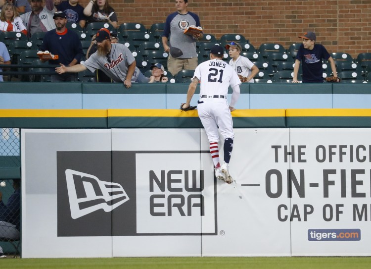 Tigers left fielder JaCoby Jones climbs the outfield wall but can't reach a two-run home run by the Astros' Tyler White in the fourth inning Tuesday in Detroit. Houston won, 5-4.