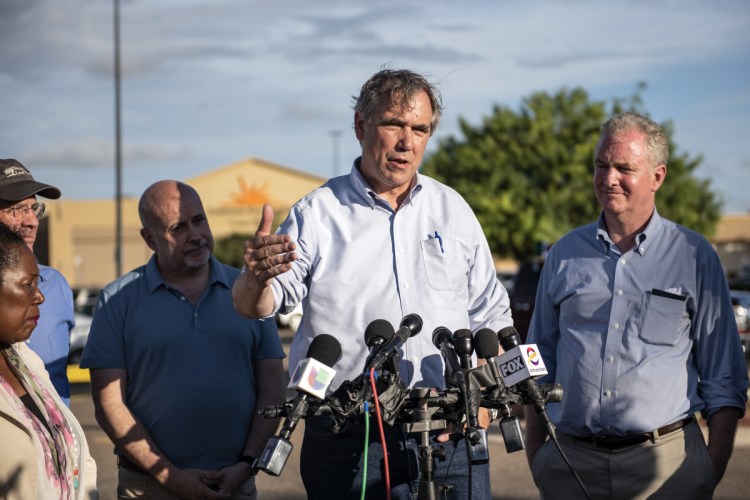 Sen. Jeff Merkley, D-Ore., second from right, speaks to members of the media outside of the Southwest Key-Casa Padre Facility in Brownsville, Texas, in June.