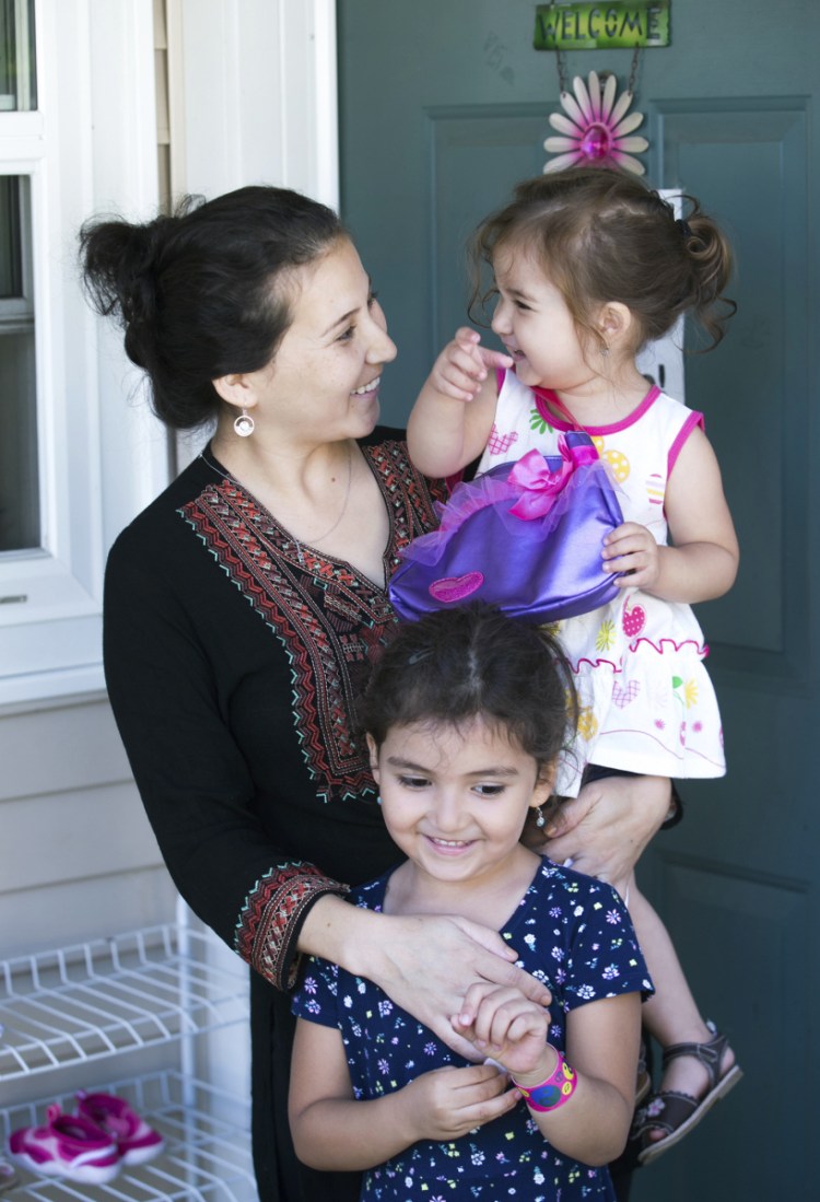 Safiya Wazir and her daughters Aaliyah and Mahwash are shown outside their home in Concord, N.H., in August.