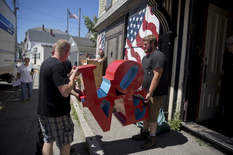 Gavan Soule, right, and Bruce Gamage, left, remove a “LOVE” sculpture from Robert Indiana’s home in July. Indiana’s artwork was removed so it could be assessed and appraised. The work was supervised by James Brannan, the attorney who is representing the late artist’s estate.