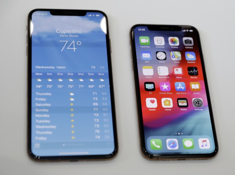 The iPhone XS, right, and the XS Max are displayed at an announcement event for new products at Apple headquarters in Cupertino, Calif.
