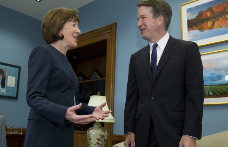 Sen. Susan Collins speaks with Supreme Court nominee Judge Brett Kavanaugh at her office before a private meeting in August. As a rare potential swing vote in the Senate, she is the focus of an intense lobbying effort.
