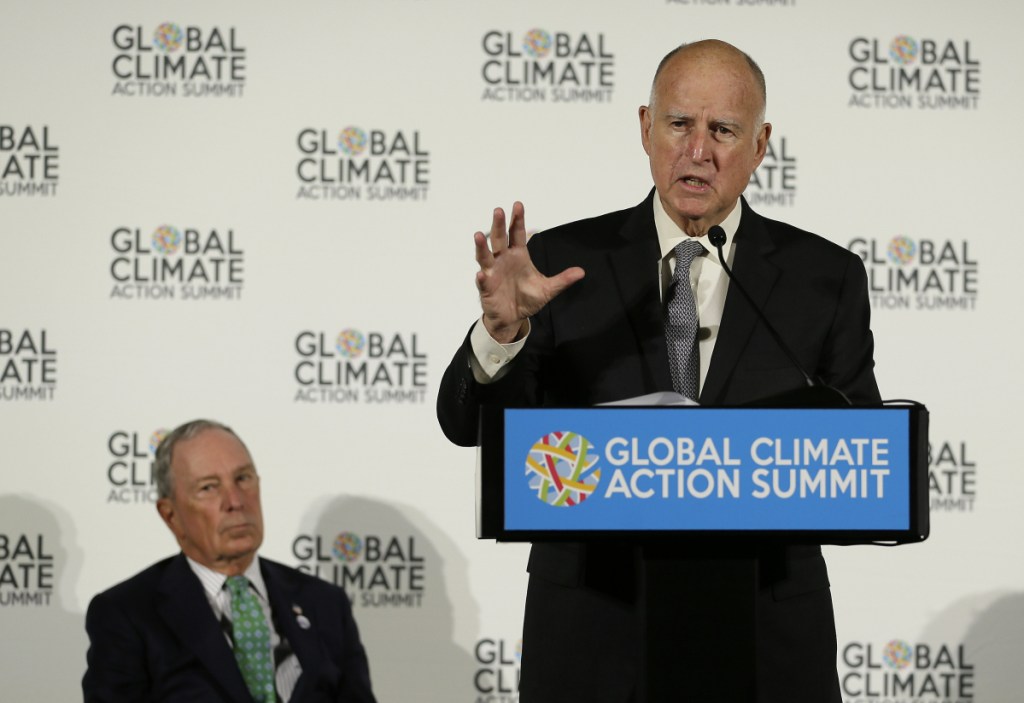 California Gov. Jerry Brown speaks as Michael Bloomberg, left, listens during a news conference at the Global Action Climate Summit Thursday, Sept. 13, 2018, in San Francisco. Gov. Brown started his global climate summit by saying that President Donald Trump will likely be remembered as a liar and fool when it comes to the environment. The Democratic Brown and former New York City Mayor Michael Bloomberg held a press conference Thursday on the first full day of the summit that is partly a rebuke of the Trump administration. (AP Photo/Eric Risberg)