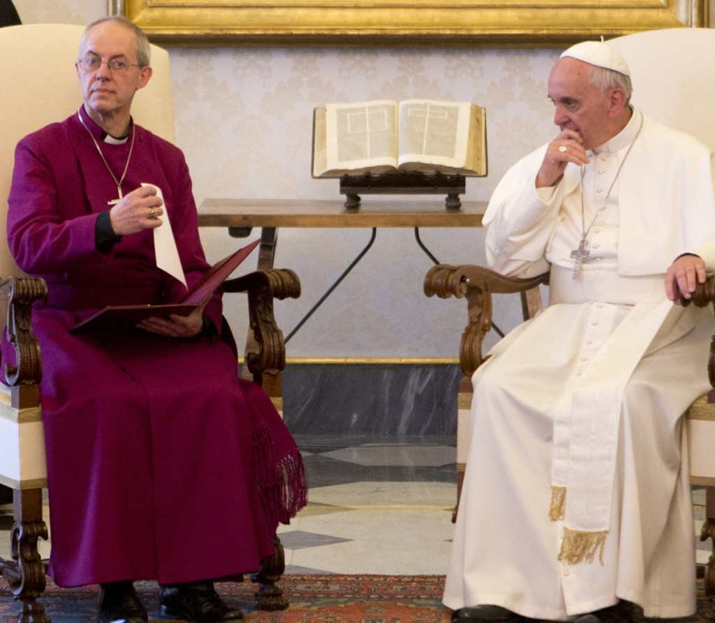 Pope Francis meets Archbishop of Canterbury Justin Welby during a private audience at the Vatican in 2013. Welby says modern corporations are using their power to suppress wages.