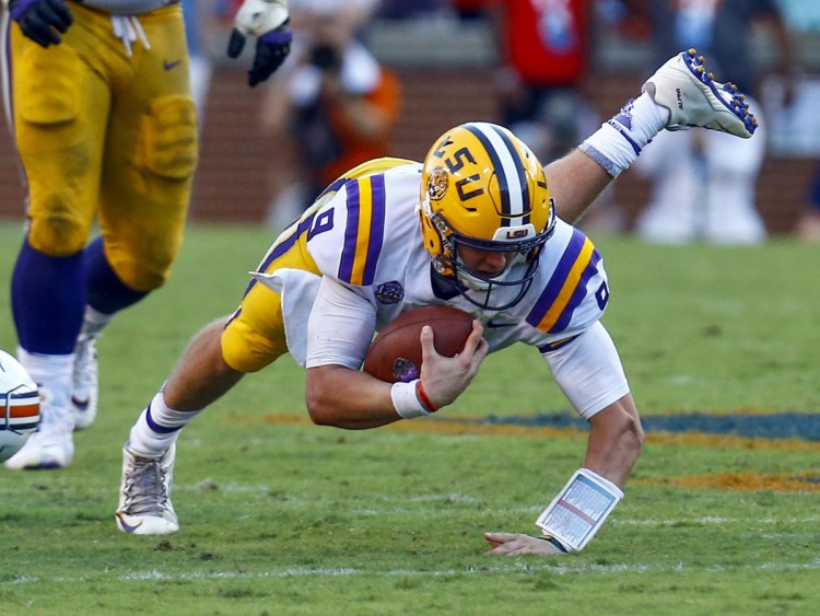 LSU quarterback Joe Burrow stretches for a extra yardage during the second half of Saturday's win over Auburn.