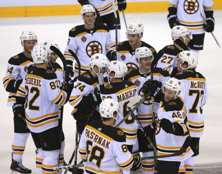 Members of the Boston Bruins celebrate after beating Calgary in the 2018 NHL China Games in Shenzhen, Southern China's Guangdong province on Saturday.