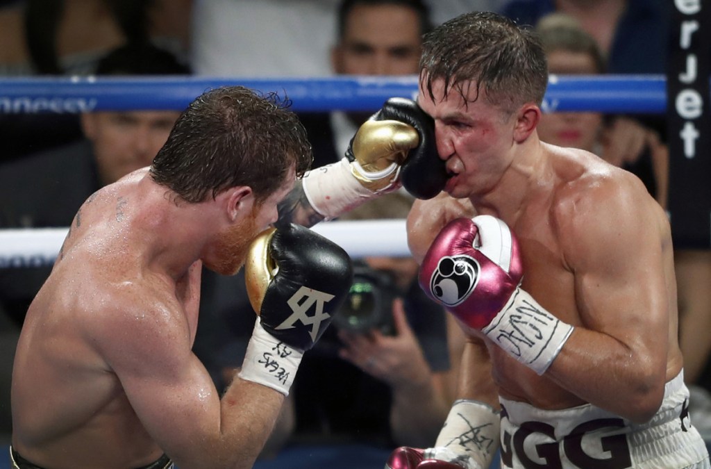 Canelo Alvarez, left, lands a punch on WBC/WBA middleweight champion Gennady Golovkin during their title fight in Las Vegas late Saturday night. Alvarez took Glolovkin's WBC/WBA titles by majority decision.