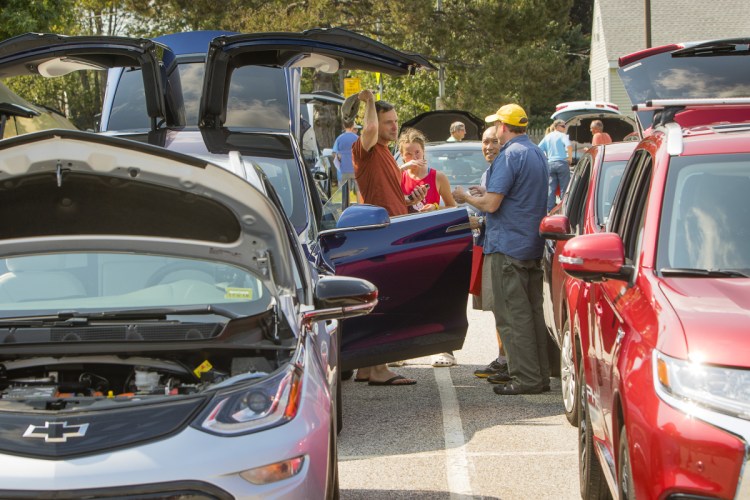 Owners of electric cars share their vehicles with people attending an electric-car event at the South Portland Community Center in September. Financial incentives announced Thursday by Gov. Janet Mills aim to make more Mainers electric-car owners.