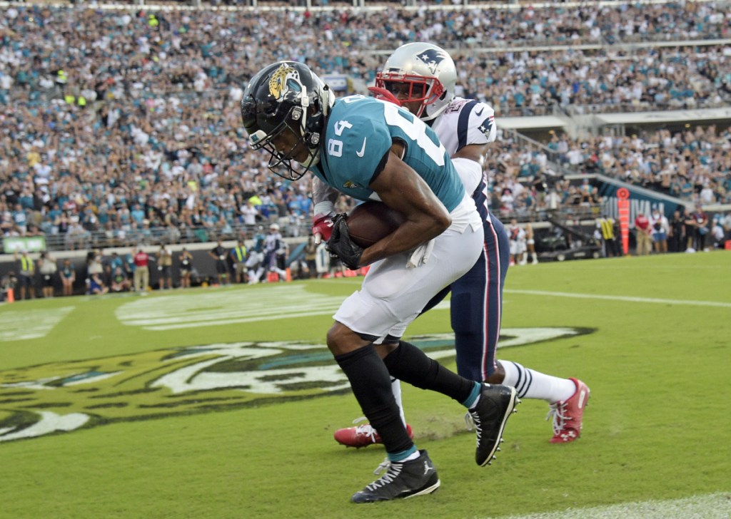 Jaguars wide receiver Keelan Cole catches a pass for a 24-yard touchdown in front of Patriots cornerback Eric Rowe in the first half Sunday in Jacksonville, Fla. Jacksonville won, 31-20.