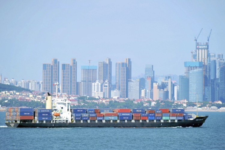 A container ship sails past the city skyline of Qingdao in eastern China's Shandong province. The Trump administration announced Mondaythat it will impose tariffs on $200 billion more in Chinese goods starting next week, escalating a trade war between the world's two biggest economies. China responded Tuesday by raising tariffs on $60 billion more American-made products.