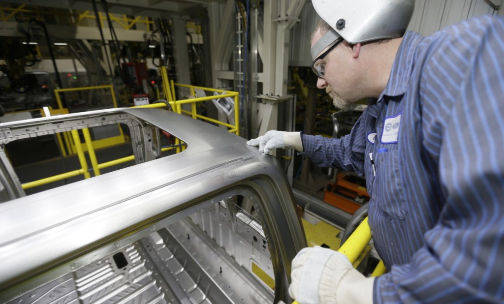 In a photo from Nov. 6, 2014, Ron Hudgin measures the roof line of the F-150 truck at the Rouge Truck Plant in Dearborn, Mich.