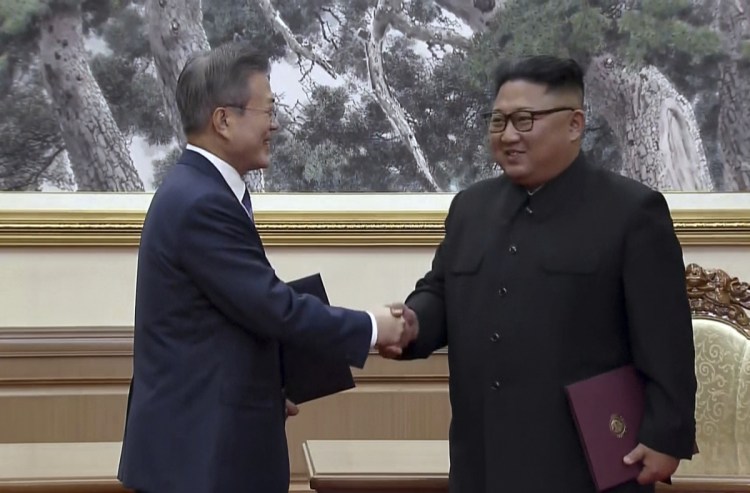 In this image made from video provided by Korea Broadcasting System, South Korean President Moon Jae-in, left, and North Korean leader Kim Jong Un shake hands after signing documents in Pyongyang, North Korea, on Wednesday.