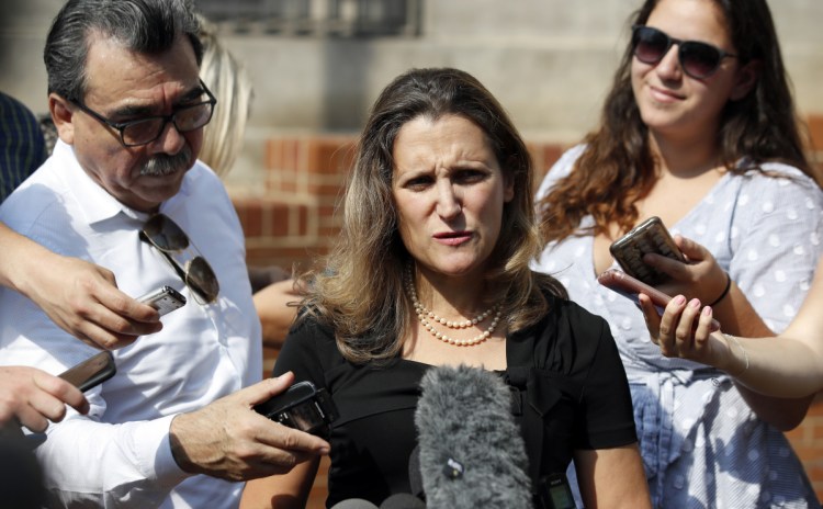 Canadian Foreign Affairs Minister Chrystia Freeland, center, speaks to the media as she arrives at the Office of the United States Trade Representative on Sept. 19.