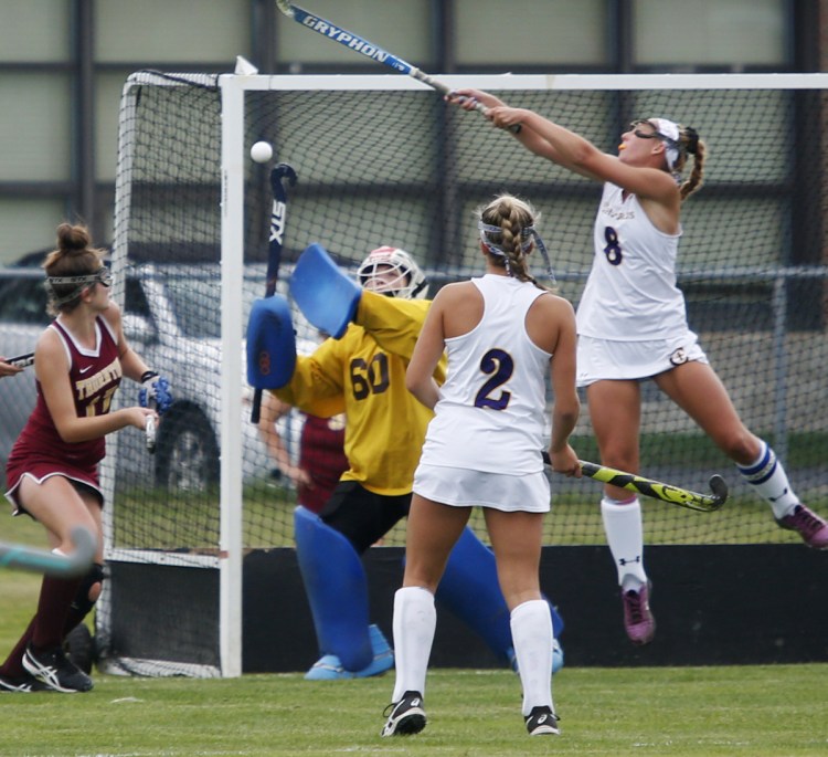 Thornton Academy goalie Madison Vachon and Bella Booth, right, of Cheverus contend for a high ball during their SMAA field hockey game Wednesday. Cheverus won, 2-0.