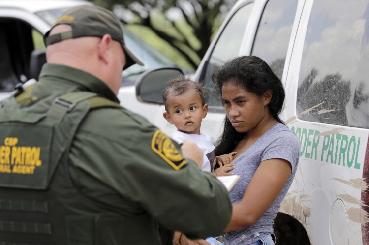 A Honduran woman holding her child surrenders to U.S. Border Patrol agents in Texas. A reader says keep-children-out policies will come back to haunt the U.S.