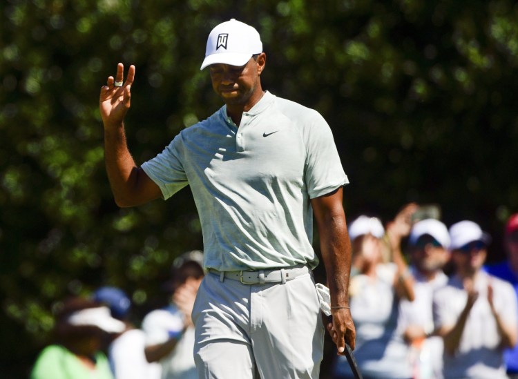 Tiger Woods acknowledges the gallery after making a birdie putt on the second hole Friday during his 2-under 68 in the second round of the Tour Championship in Atlanta.
