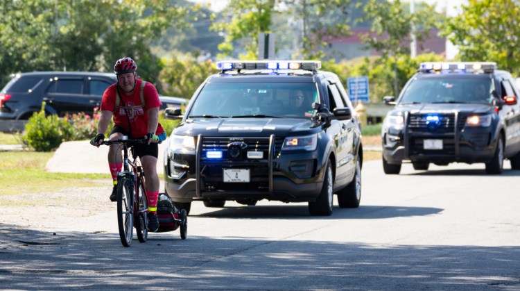 Brian McCarthy, a South Portland police officer, rounds the last corner in his weeklong ride.