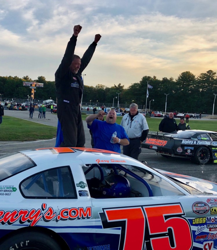 Gary Smith of Bangor raises his hands into the air in victory lane after winning the Pro All Stars Series 150 at Beech Ridge Motor Speedway in Scarborough on Sunday.