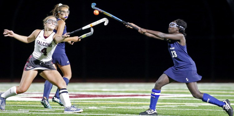 Reilly Lefebvre of Freeport, left, and Hwida Nawass of Poland compete for the ball Monday night during Freeport's 4-0 victory in a Western Maine Conference field hockey game.