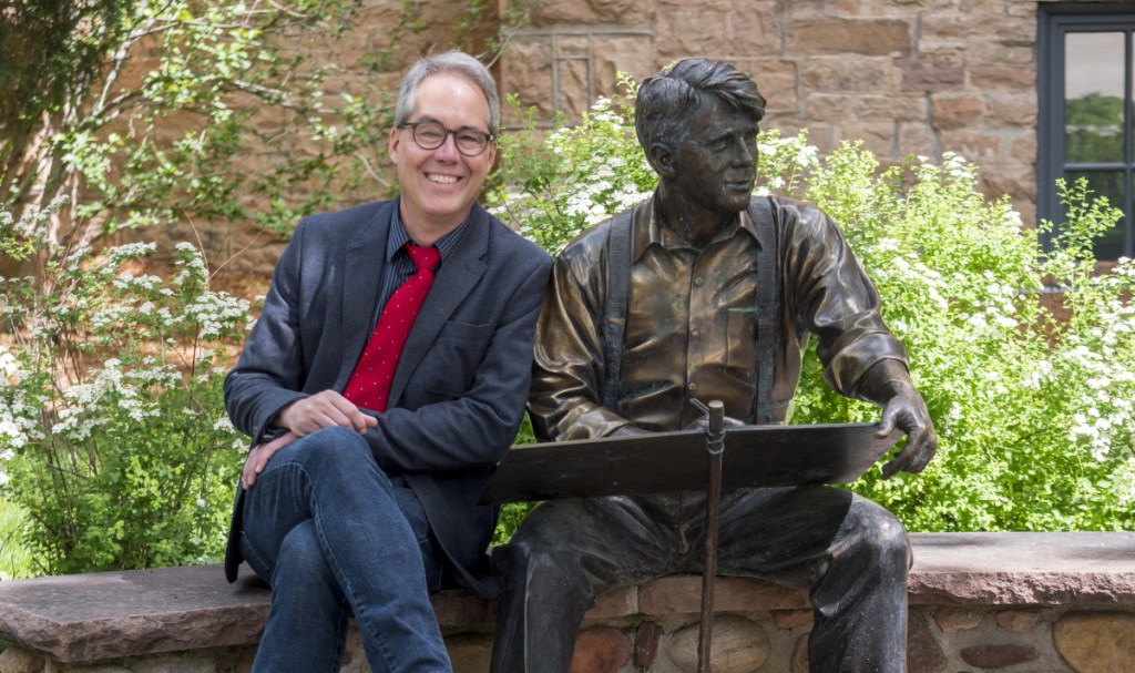 Former Denver Post editorial page editor Chuck Plunkett, shown alongside a statue of Robert Frost at the University of Colorado Boulder, will be honored Oct. 8 at Colby College.