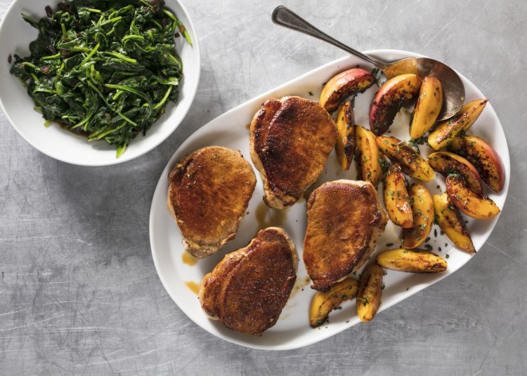 Pan-Seared Thick-Cut Boneless Pork Chops with Peaches and Spinach.